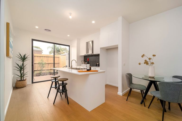 Centenary, Seaford: a kitchen and dining area with a table and chairs