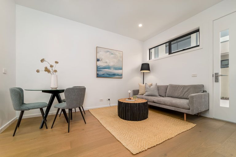 Centenary, Seaford: a living room with a couch and table