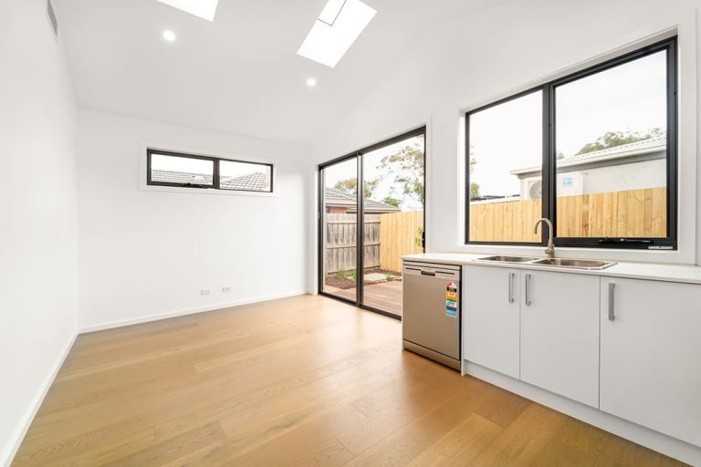 Centenary, Seaford: a kitchen with a stainless steel sink and a wood floor