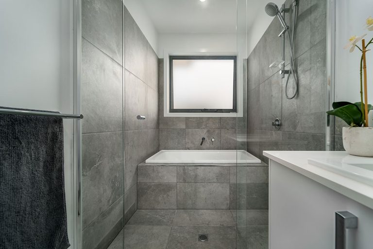 Centenary, Seaford: a bathroom with a bathtub and shower