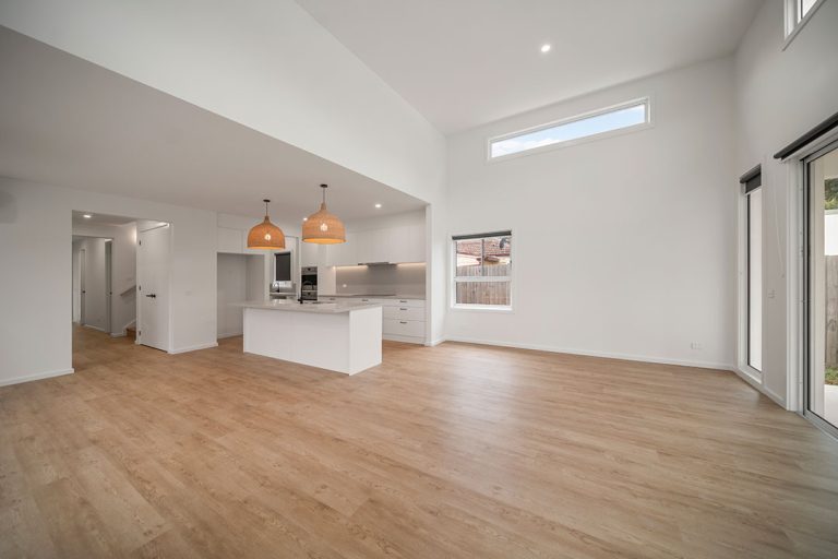 Seaford Road, Seaford: a large white room with a wood floor and a kitchen island