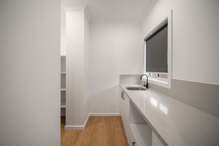 Seaford Road, Seaford: a white kitchen with a sink and a window