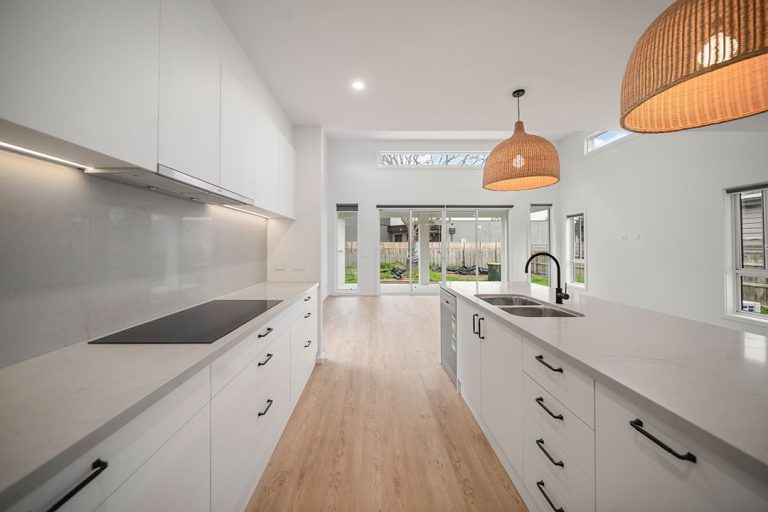 Seaford Road, Seaford: a kitchen with white cabinets and a wood floor